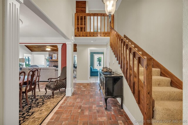 3112 Shore Dr, Grove, OK 74344 - entryway with decorative columns, a high ceiling, brick flooring, stairway, and a ceiling fan