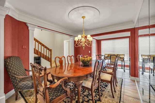 3112 Shore Dr, Grove, OK 74344 - dining room with decorative columns, crown molding, a chandelier, stairway, and baseboards
