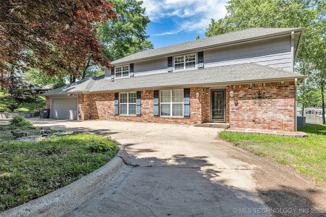 3112 Shore Dr, Grove, OK 74344 - traditional-style home with an attached garage, concrete driveway, brick siding, and a shingled roof