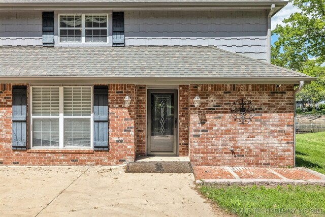 3112 Shore Dr, Grove, OK 74344 - doorway to property with roof with shingles and brick siding