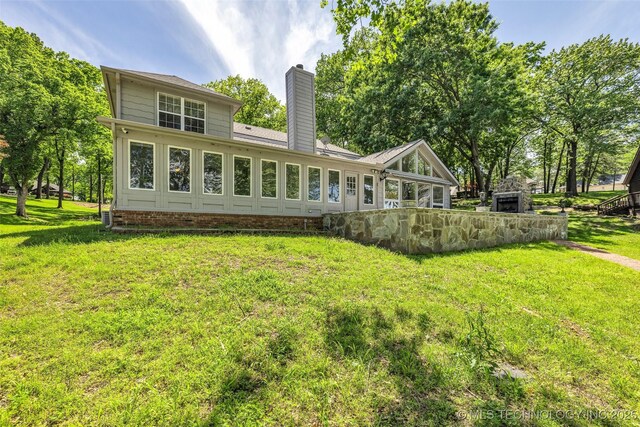 3112 Shore Dr, Grove, OK 74344 - rear view of house featuring a chimney and a lawn