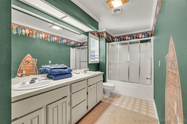 3112 Shore Dr, Grove, OK 74344 - bathroom with tile patterned floors, double vanity, a textured ceiling, combined bath / shower with glass door, and toilet