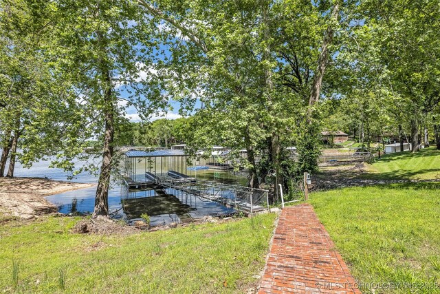 3112 Shore Dr, Grove, OK 74344 - dock featuring boat lift and a lawn
