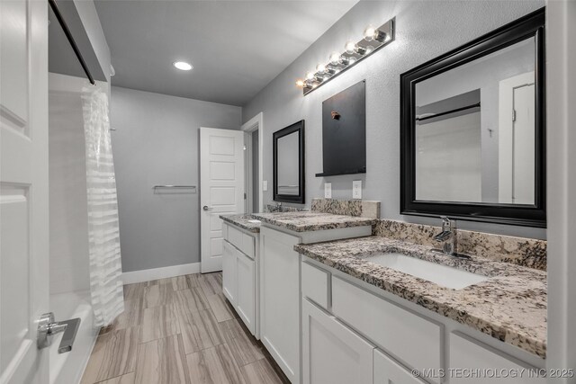 3130 E 47th St, Tulsa, OK 74105 - full bathroom featuring two vanities, baseboards, recessed lighting, and shower / bath combo