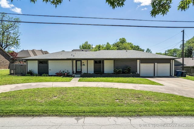 3130 E 47th St, Tulsa, OK 74105 - view of front of property featuring driveway, a garage, and brick siding