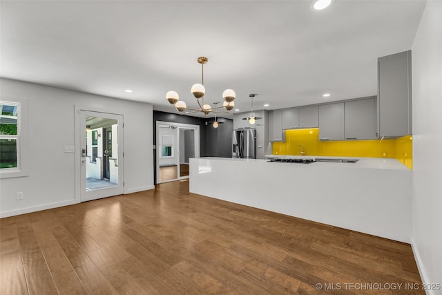 3130 E 47th St, Tulsa, OK 74105 - kitchen featuring gray cabinets, stainless steel fridge, recessed lighting, a peninsula, and wood finished floors