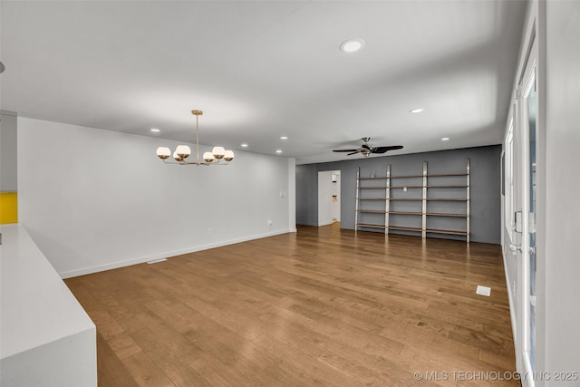 3130 E 47th St, Tulsa, OK 74105 - unfurnished room featuring recessed lighting, wood finished floors, a chandelier, a ceiling fan, and baseboards