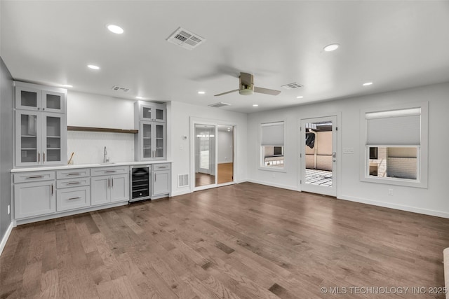 3130 E 47th St, Tulsa, OK 74105 - indoor wet bar featuring wine cooler, ceiling fan, wood finished floors, recessed lighting, and baseboards