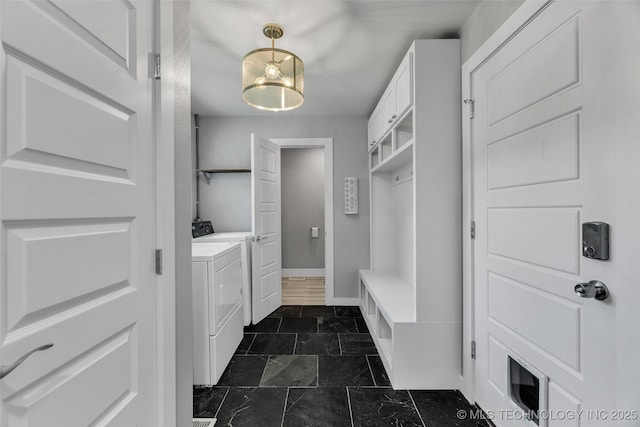3130 E 47th St, Tulsa, OK 74105 - mudroom featuring washing machine and dryer, baseboards, and dark stone finish floors