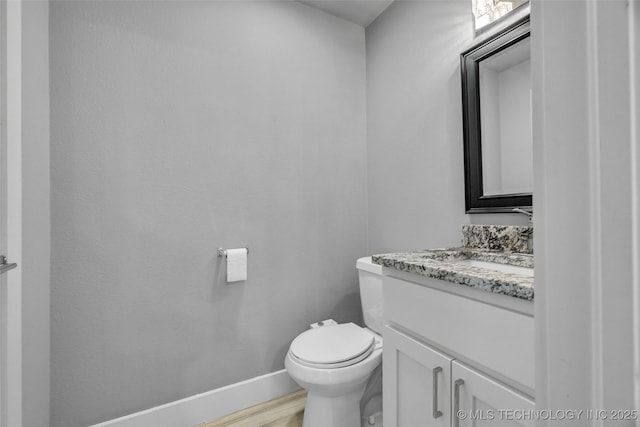 3130 E 47th St, Tulsa, OK 74105 - bathroom featuring toilet, vanity, baseboards, and wood finished floors