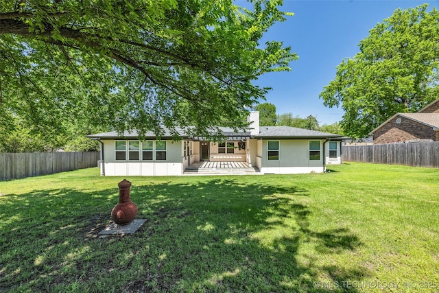 3130 E 47th St, Tulsa, OK 74105 - back of property featuring stucco siding and a chimney