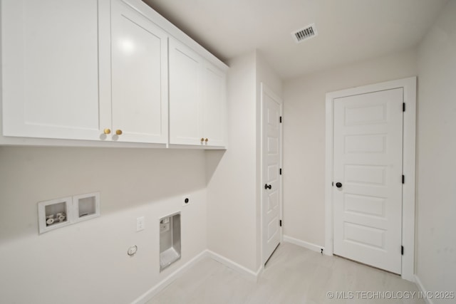 laundry area featuring cabinet space, hookup for a washing machine, hookup for an electric dryer, baseboards, and gas dryer hookup