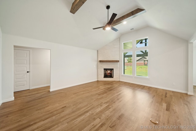unfurnished living room with light wood-style floors, a large fireplace, a ceiling fan, and baseboards