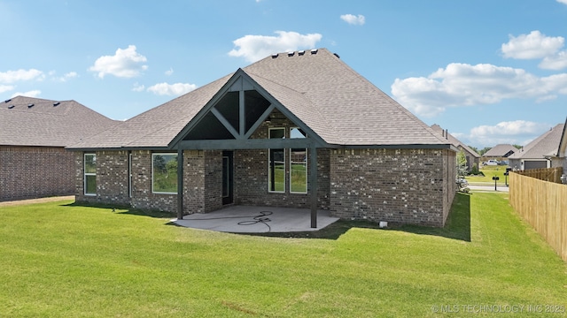 rear view of house featuring a patio area and brick siding