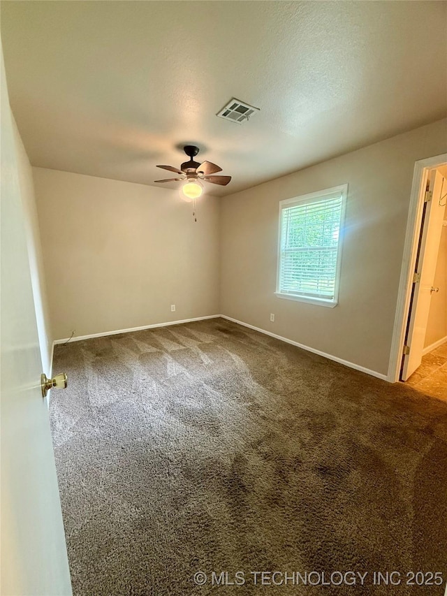 empty room with a ceiling fan, carpet floors, and baseboards