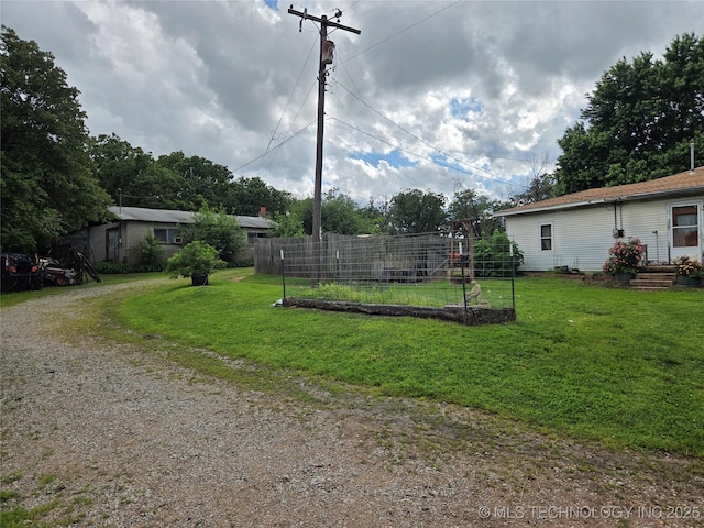 35530 W 261st St, Bristow, OK 74010 - view of green lawn with a vegetable garden and dirt driveway