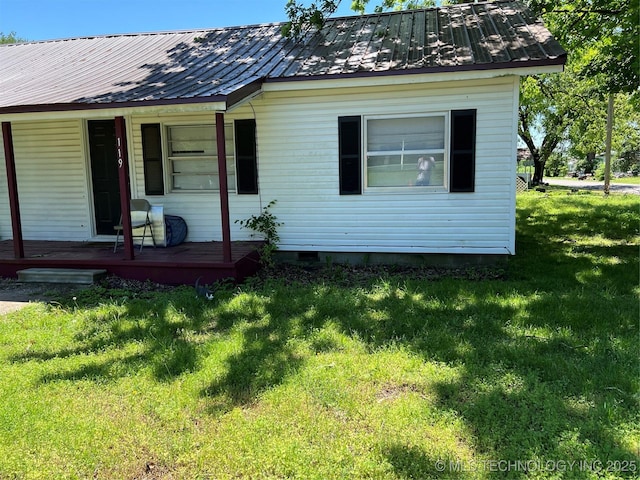 119 E Elmwood Ave, Morris, OK 74445 - view of front of home with metal roof, a front yard, and covered porch