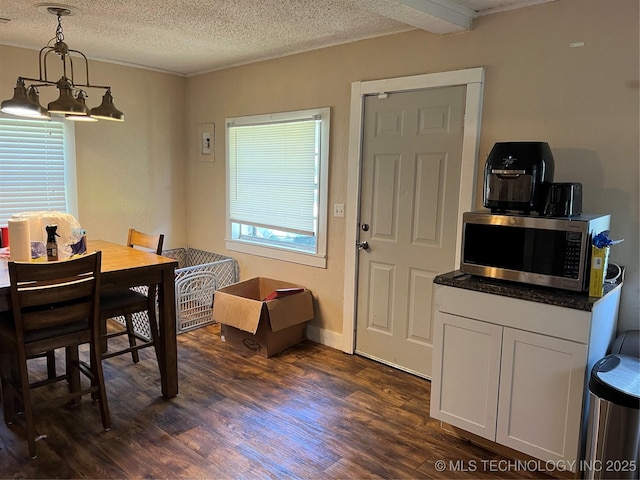 119 E Elmwood Ave, Morris, OK 74445 - dining room featuring dark wood-style flooring and a textured ceiling