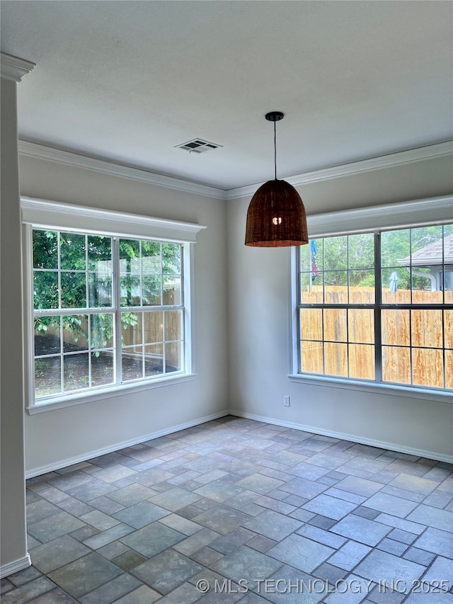 unfurnished room featuring baseboards and crown molding