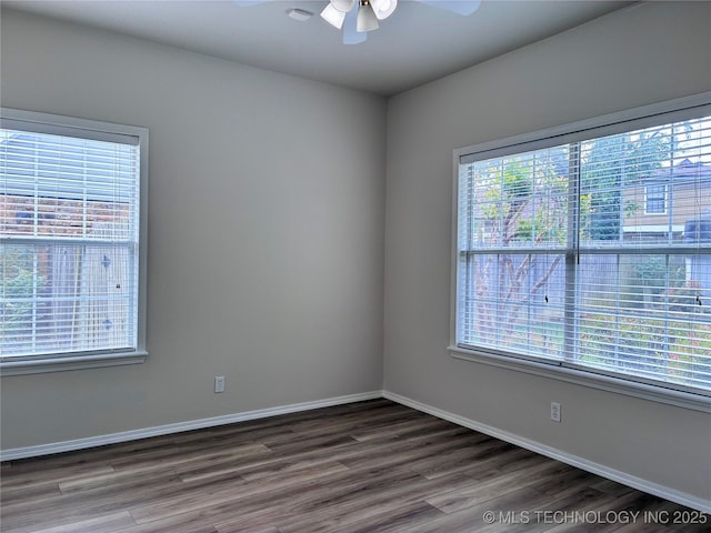 unfurnished room with a ceiling fan, plenty of natural light, and wood finished floors