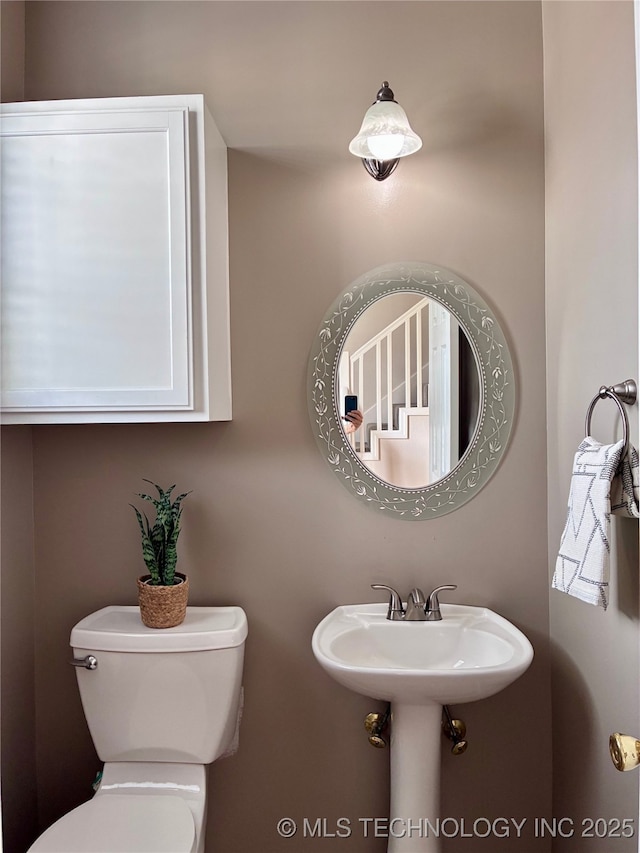 half bath featuring toilet