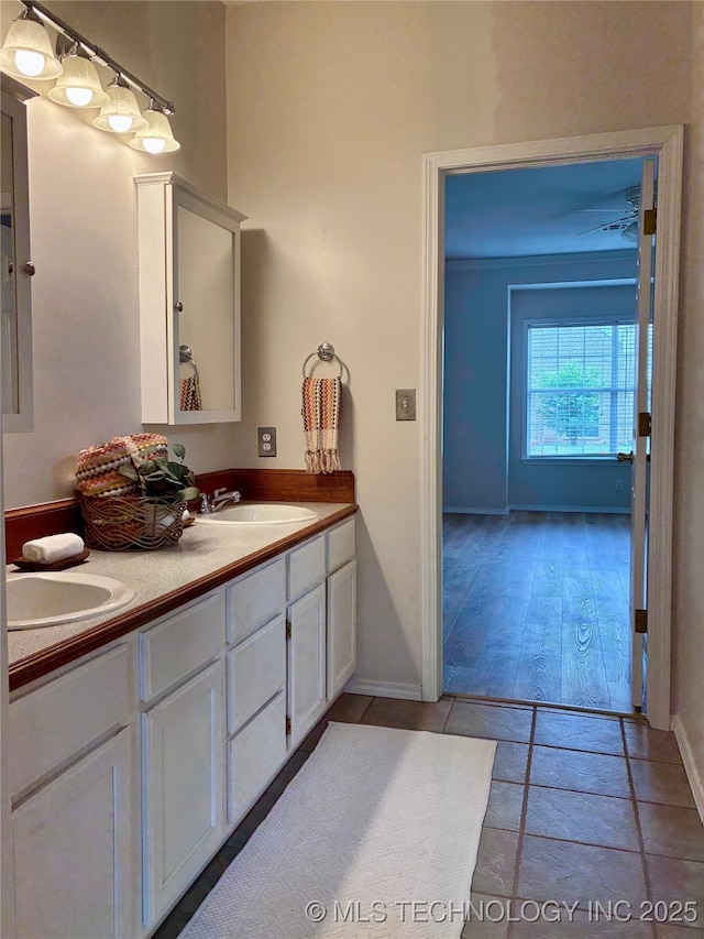 bathroom featuring double vanity and baseboards