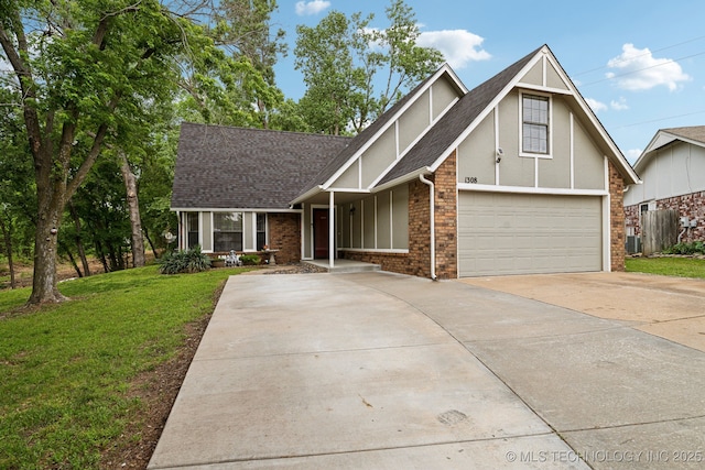 tudor house with concrete driveway, a front lawn, brick siding, roof with shingles, and stucco siding