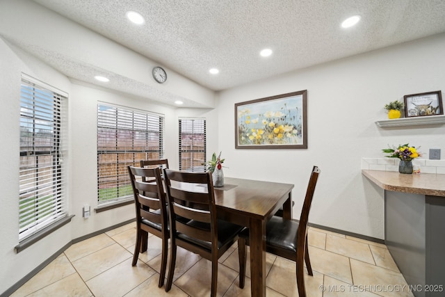 dining room featuring recessed lighting, a textured ceiling, baseboards, and light tile patterned flooring