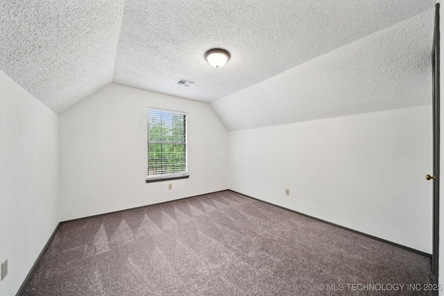 bonus room featuring carpet floors, vaulted ceiling, a textured ceiling, and baseboards