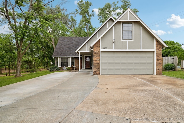 view of front of home featuring driveway, stucco siding, an attached garage, and roof with shingles