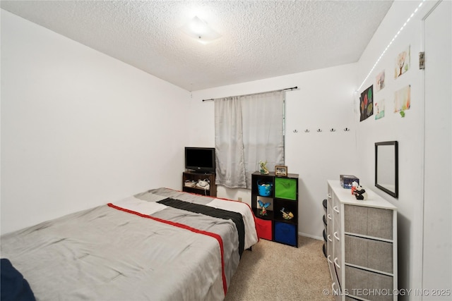 carpeted bedroom featuring a textured ceiling