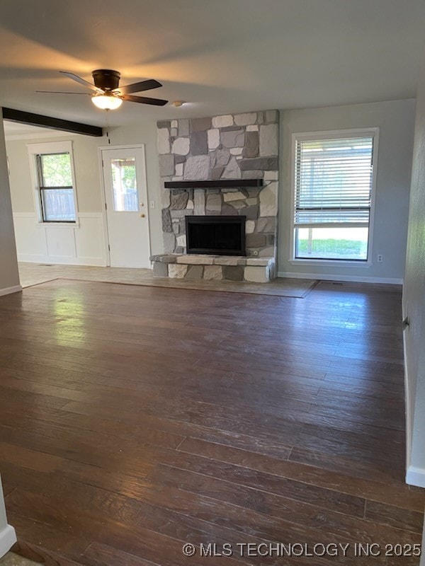 unfurnished living room with wood-type flooring, a fireplace, and a ceiling fan