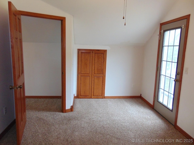 additional living space with carpet flooring, lofted ceiling, and baseboards