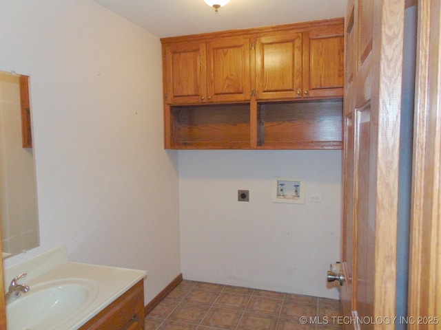 laundry area featuring electric dryer hookup, washer hookup, and a sink