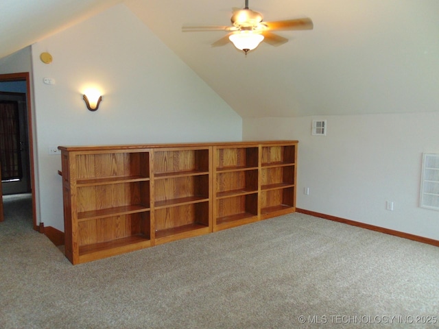 additional living space with carpet flooring, ceiling fan, lofted ceiling, and baseboards