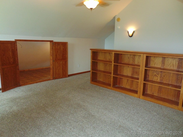 bonus room with vaulted ceiling, carpet flooring, and ceiling fan