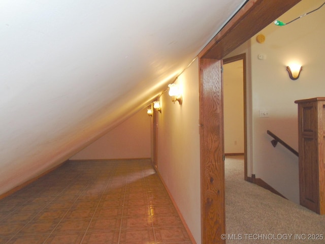 additional living space featuring lofted ceiling