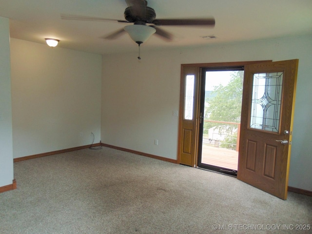 spare room featuring carpet flooring and baseboards