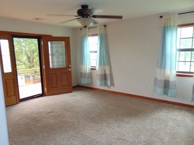 empty room featuring carpet flooring, ceiling fan, and baseboards