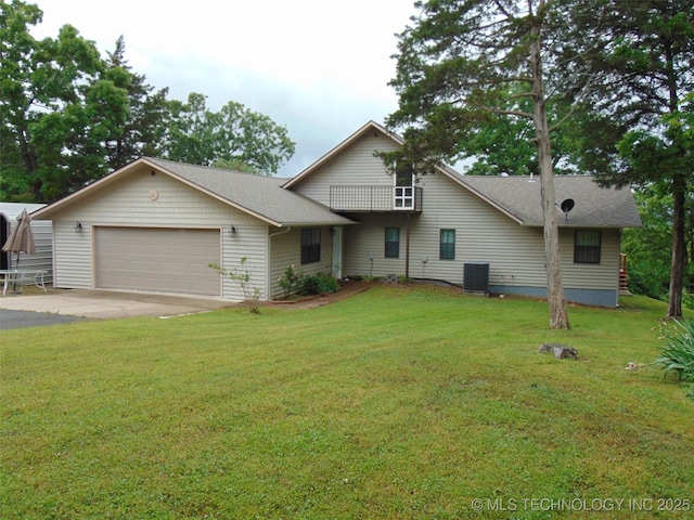 traditional home featuring an attached garage, a front lawn, driveway, and central AC