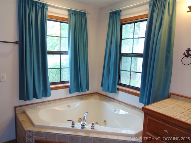 full bathroom with a whirlpool tub