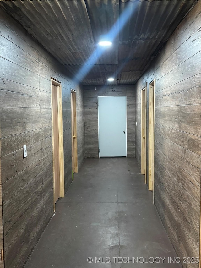 8326 N 496th Rd, Tahlequah, OK 74464 - hallway featuring wooden walls and concrete flooring