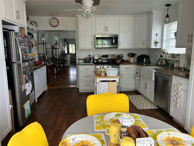 509 Poplar St, Fort Gibson, OK 74434 - kitchen featuring appliances with stainless steel finishes, a sink, healthy amount of natural light, and white cabinetry