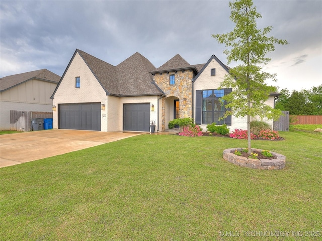 french country home with stone siding, concrete driveway, an attached garage, and a shingled roof