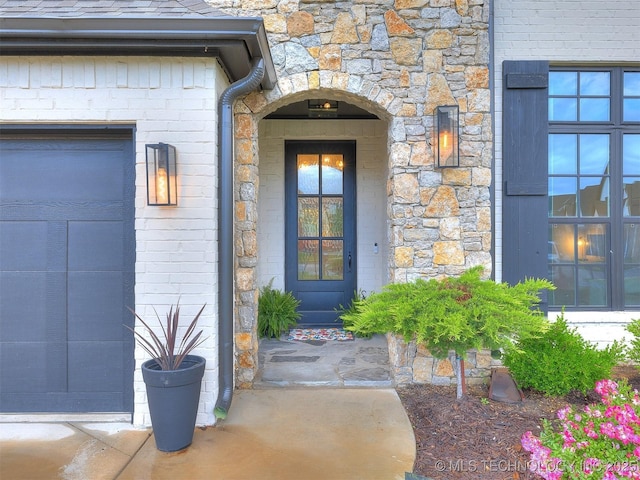 view of exterior entry featuring stone siding