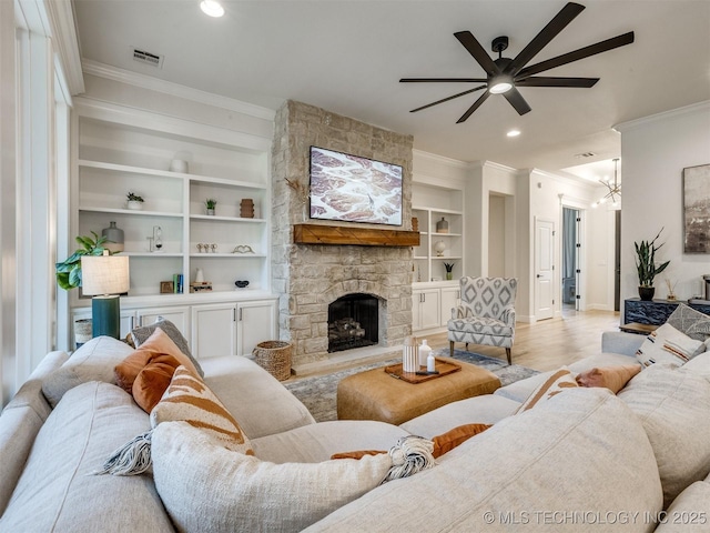 living room featuring ornamental molding, ceiling fan, built in features, baseboards, and light wood-style flooring