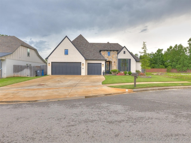 french country home with driveway and a garage