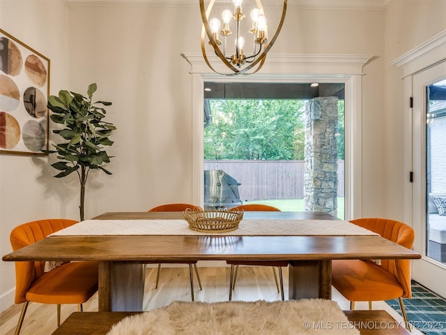 dining space featuring a chandelier and ornamental molding