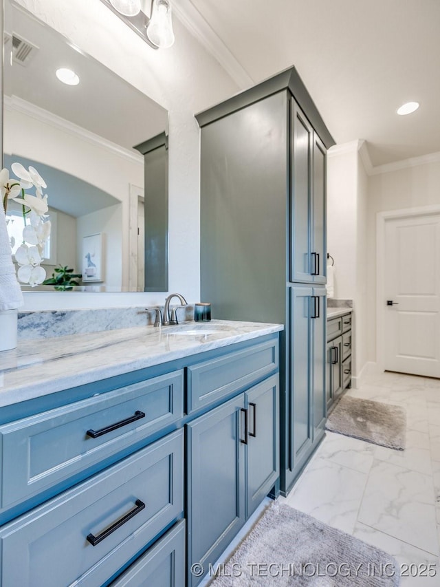 bathroom with ornamental molding, vanity, marble finish flooring, and recessed lighting