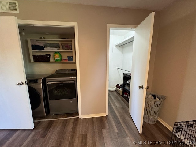 4302 E 67th St Unit 656, Tulsa, OK 74136 - laundry area with dark wood finished floors, washer and clothes dryer, and baseboards